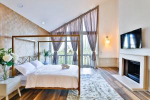 a bedroom with a large bed and a fireplace at 6BR-Music Studio-Pool-Spa & Games in Sherman Oaks +85 photos