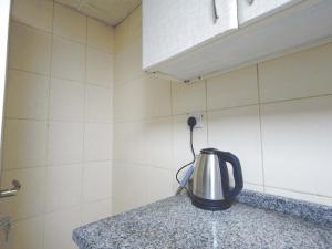 a tea kettle on a counter in a kitchen at One Bedroom Twin Bed Fully Furnished in Sharjah