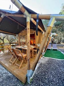 a wooden deck with a table and chairs at Camper Village in Santo Stefano al Mare +32 photos