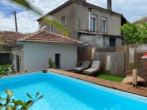a swimming pool in front of a house at Oneiropetra Luxury House in Argalasti