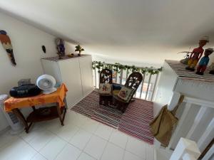 a kitchen with a table and two chairs in a room at Duplex Cozy - Piscine - Vue Mer in Carqueiranne