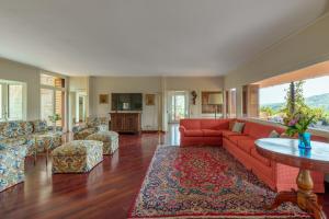 a living room with a red couch and a table at VILLA LIA 10, Emma Villas in Ascoli Piceno
