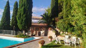 a house with a pool and trees and chairs at Orsola in Vigne