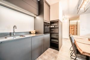 a kitchen with a table and a dining room at Apartment Rivulet, Châtel- by EMERALD STAY in Châtel +36 photos