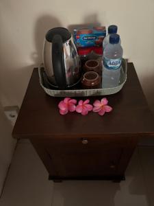 a table with a tea kettle and flowers on it at Kubu Artha Bungalow Nusa Penida in Nusa Penida +45 photos