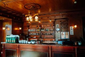 a bar in a restaurant with a chandelier at Hotel Delta in Durrës +30 photos