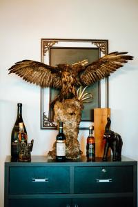 a dresser with an eagle statue on top of it at Hotel Delta in Durrës