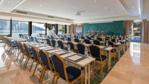 a conference room with long tables and chairs at Swiss Diamond Boutique Hotel - La Romantica in Melide +165 photos