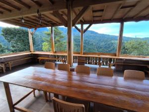 a table and chairs in a room with a view at Maison Manendra - Bromo in Gubukklakah