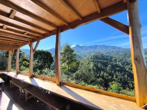 a view from the balcony of a house with mountains in the background at Maison Manendra - Bromo in Gubukklakah