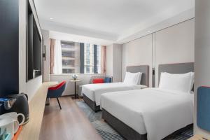 a hotel room with two beds and a tv at Holiday Inn Express Xi'an Daxing by IHG in Xi'an