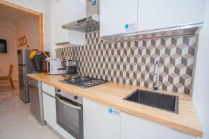 a kitchen with a sink and a counter top at SeaBreeze Gallipoli - Lido San Giovanni in Gallipoli