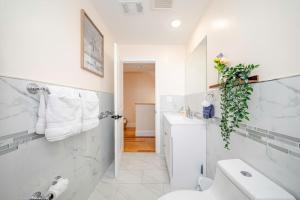 a white bathroom with a toilet and a sink at 37 - 3BR Quincy - Cozy Townhouse near Adams Park in Quincy +86 photos