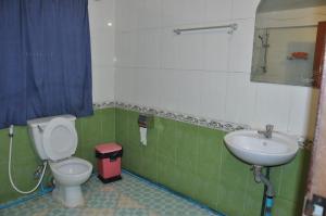 a bathroom with a toilet and a sink at Velkommen Guesthouse Phnom Penh in Phnom Penh +67 photos