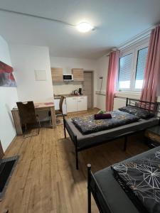 a living room with two beds and a desk at Schicke Apartments in Messenähe in Hannover