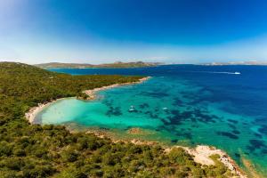 an aerial view of a beach with turquoise water at La Sciumara with beach access - Happy Rentals in Cannigione