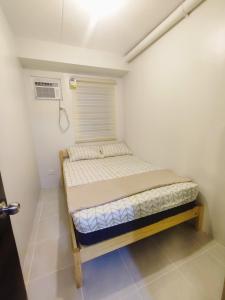 a small bedroom with a bed in a room at Cebu Homestay Rental in Mandaue City