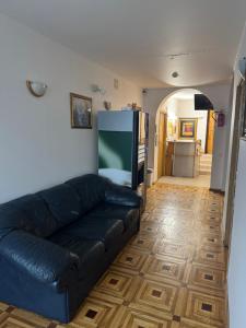 a living room with a couch and a tv at Turnė Guest House in Šiauliai