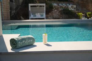 a pool with a pillow and a candle next to it at Salino Port Soller-Adults Only in Port de Soller +112 photos