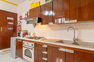 a kitchen with wooden cabinets and a stove top oven at Nonna Lina in Castel di Ieri +10 photos