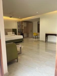 a large room with a bed and a table at Ayana Resorts in Hyderabad