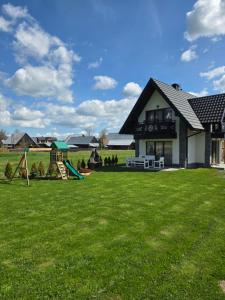 a house with a yard with a playground at Family HOUSE in Witów
