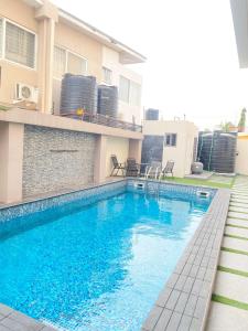 a swimming pool in front of a building at Executive One bed - East legon in Accra