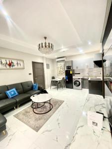 a living room with a couch and a table at Executive One bed - East legon in Accra