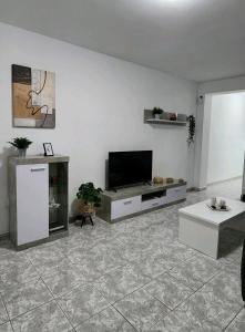 a living room with a flat screen tv on a wall at Fantastic Holiday Apartment in Arona
