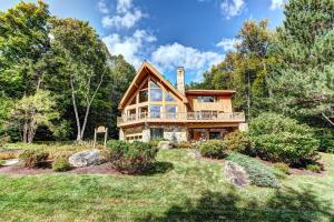 a house in the woods with a yard at New Stratton Mountain - Sleeps 10 in Stratton Valley
