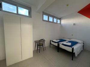Postel nebo postele na pokoji v ubytování Meet Hostel Cervia