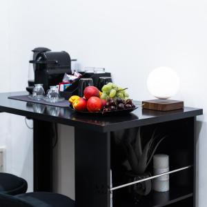 a table with a plate of fruit on it at MEA Suite in Palermo +2 photos