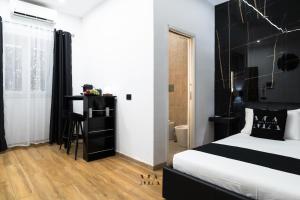 a bedroom with a bed with a black headboard at MEA Suite in Palermo