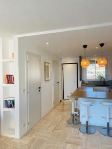 a kitchen with a table and stools in a room at Cannes Palm Beach - Brand New Studio - Oasis of Calm in Cannes