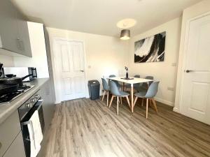 a kitchen and dining room with a table and chairs at Earl House in Coxhoe