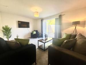 a living room with a couch and a table at Earl House in Coxhoe