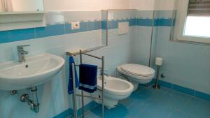 un bagno blu e bianco con un water e un lavandino di Casa Domenica a Baveno Altre 22 foto
