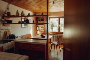 a kitchen with a counter and a table and chairs at Haus am Weiher in Schwangau +28 photos