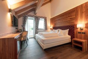 Voodi või voodid majutusasutuse Hotel Chalet Sas Morin toas