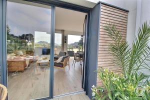 a house with sliding glass doors leading to a living room at Ker touro in Trégastel +40 photos