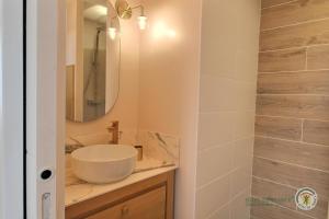 a bathroom with a sink and a mirror at Ker touro in Trégastel