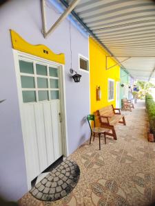 a patio with a white door and a table and chairs at Estancia Colibrí in Ricaurte