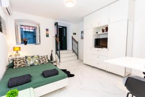 Un dormitorio blanco con una cama y un escritorio. en The Little Prince apartman Herceg Novi, en Herceg-Novi