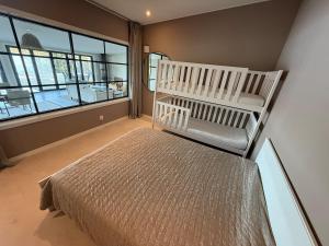 a bedroom with a bed and a large window at Luxury leisure villa - private beach in Jönköping