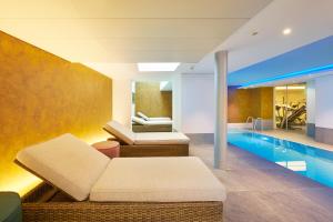 a living room with a swimming pool and a couch at Hotel Ambassador in Bern