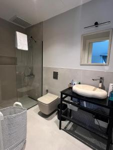 a bathroom with a shower and a toilet and a sink at NisUrla in Urla +43 photos
