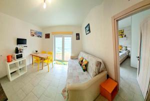 a living room with a couch and a table at Geltoni apartamentai in Palanga