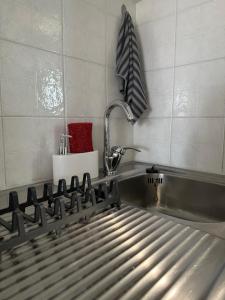 a kitchen with a stainless steel stove and a sink at Odysseas rooms in Kalón Nerón