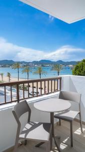 a table and chairs on a balcony with a view of the ocean at Sunside Ibiza Studios - Only Adults- Formerly known as Central Park in San Antonio