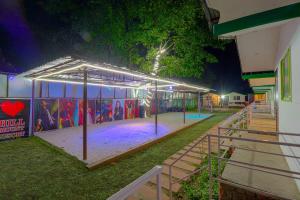 a building with a basketball court in a park at night at The Hill Mount Resort Shivpuri in Rishīkesh